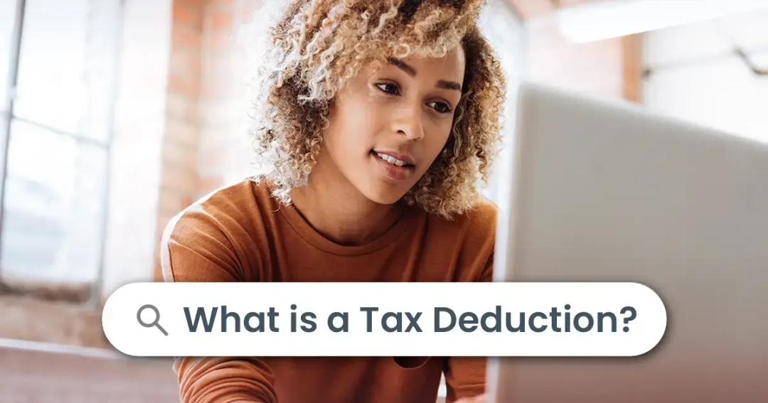 A young woman searching to learn more about what a tax deduction is.