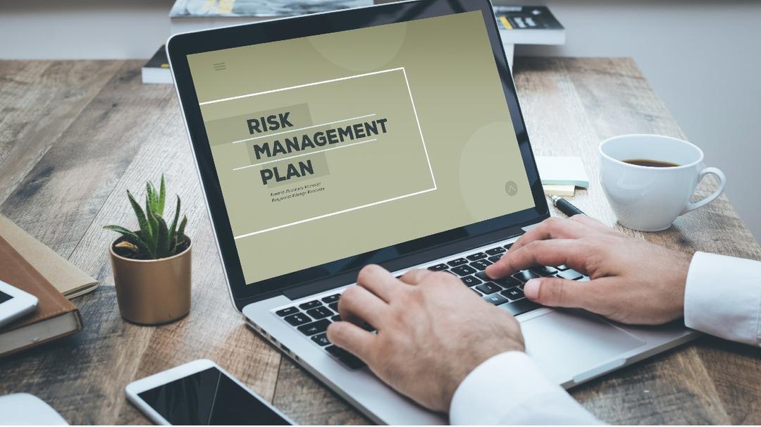 laptop screen reads Risk Management Plan