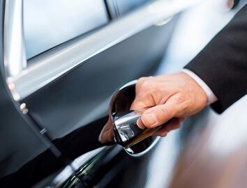 Person about to open a car door