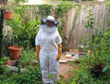 Beekeeper standing in a garden