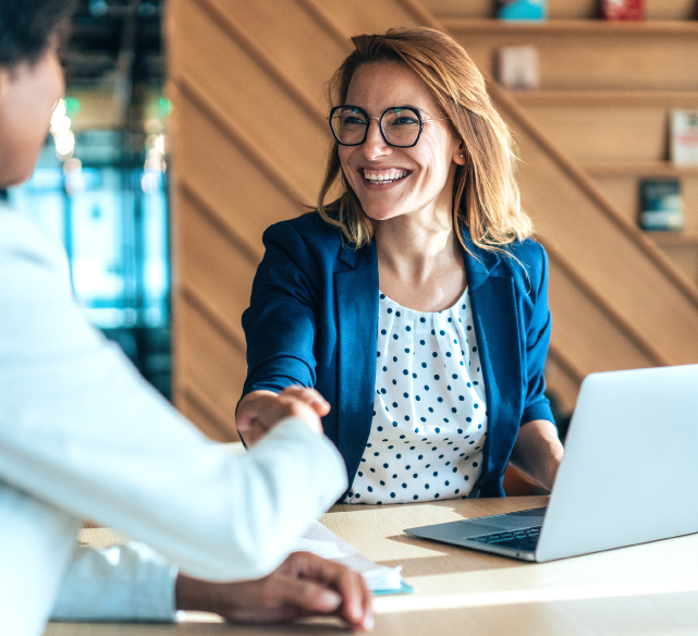 Woman shaking hands at business meeting